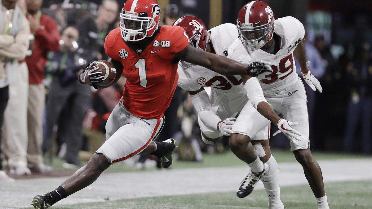 Georgia running back Sony Michel runs doer a first down during the first half of the NCAA college football playoff championship game against Alabama Monday, Jan. 8, 2018, in Atlanta.