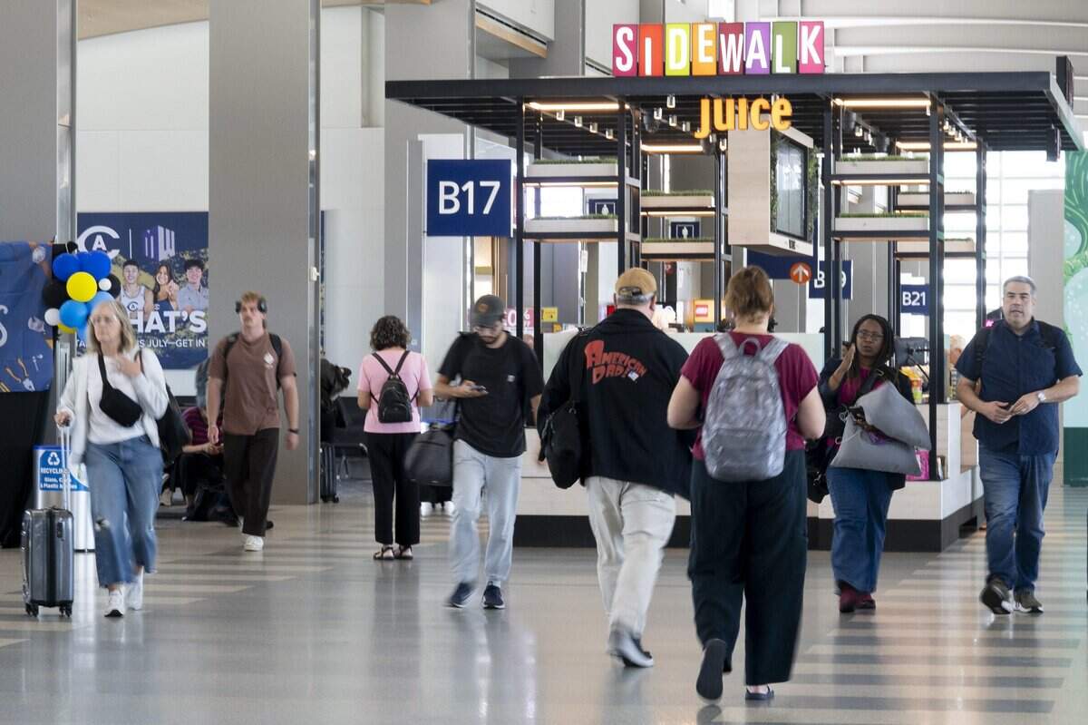 People walk past the Sidewalk Juice kiosk in terminal B at Sacramento International Airport on Wednesday, June 17, 2026.