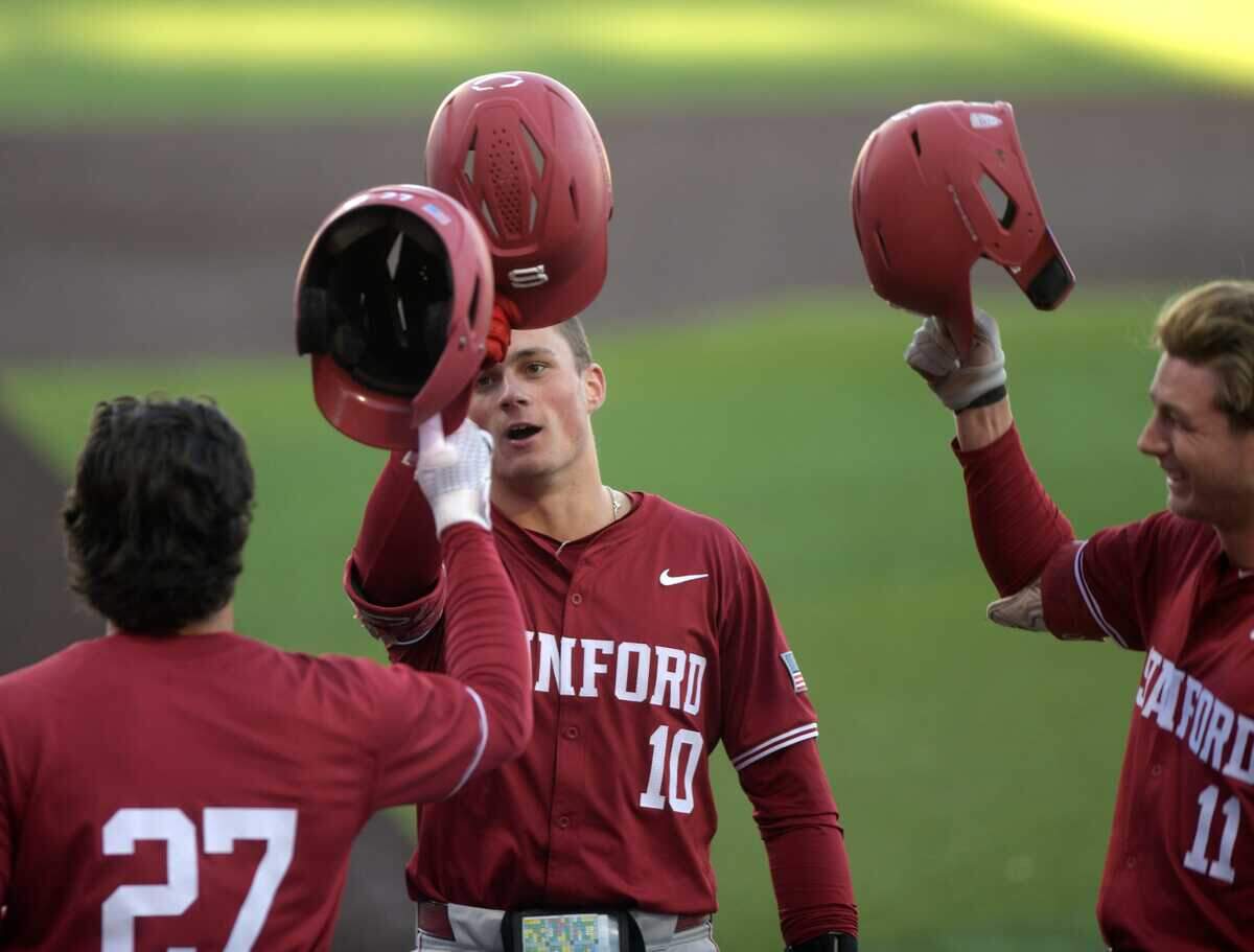 Stanford catcher Malcolm Moore (10) taps helmets after hitting a home run against Texas Tech on April 1, 2024, at Rip Griffin Park in Lubbock, Texas.