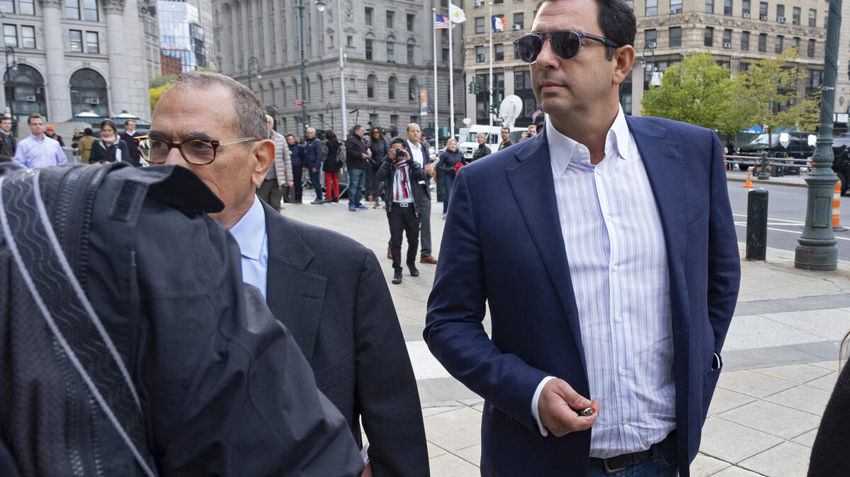 Andrey Kukushkin, right, leaves federal court, Thursday, Oct. 17, 2019, in New York. Kukushkin and David Correia pleaded not guilty Thursday to conspiring with associates of Rudy Giuliani to make illegal campaign contributions. They are among four men charged with using straw donors to make illegal contributions to politicians they thought could help their political and business interests. (AP Photo/Craig Ruttle)