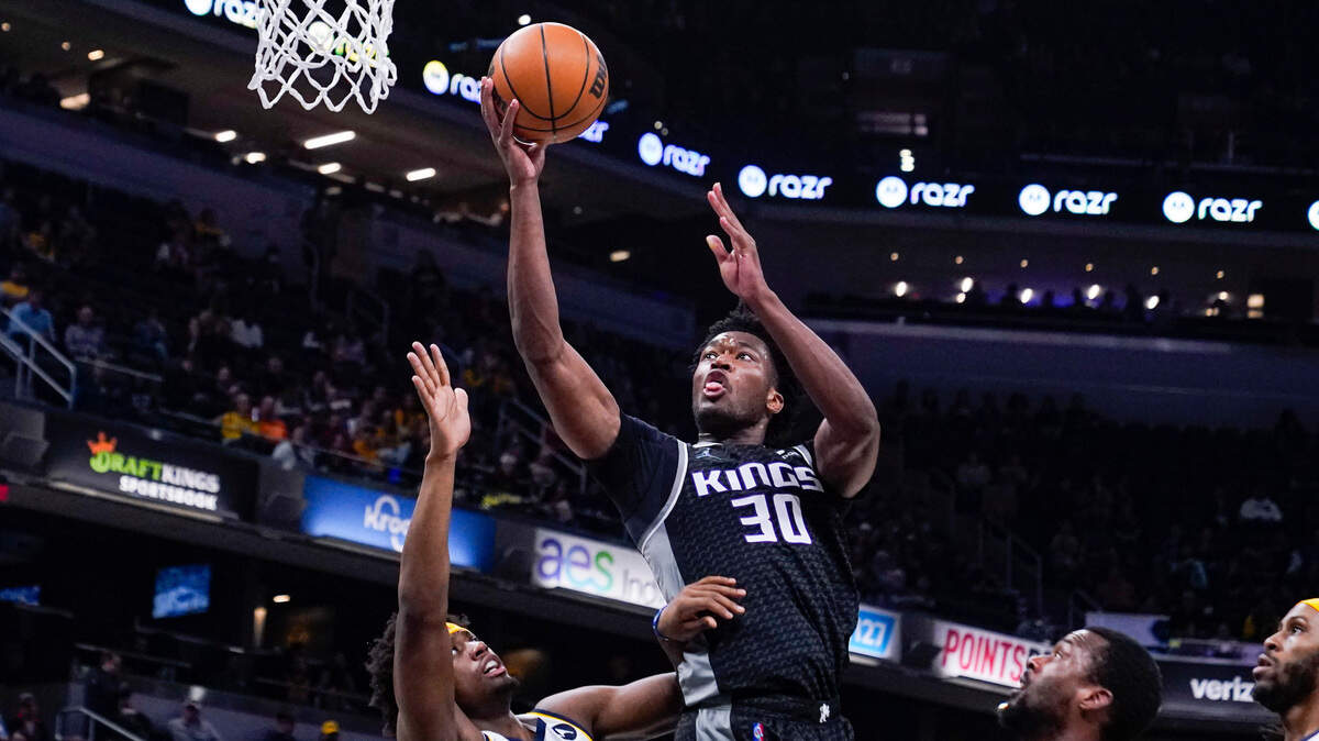 Sacramento Kings center Damian Jones (30) shoots over Indiana Pacers guard Terry Taylor (32) during the first half of an NBA basketball game in Indianapolis, Wednesday, March 23, 2022. (AP Photo/Michael Conroy)