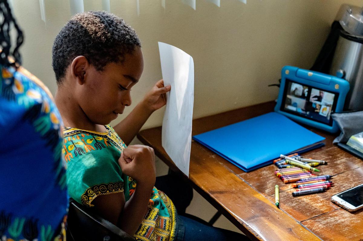 First grader Tulley, 6, pumps his fist before starting with online distance learning from Leataata Floyd Elementary School at his kitchen table, Friday, Oct. 2, 2020.
