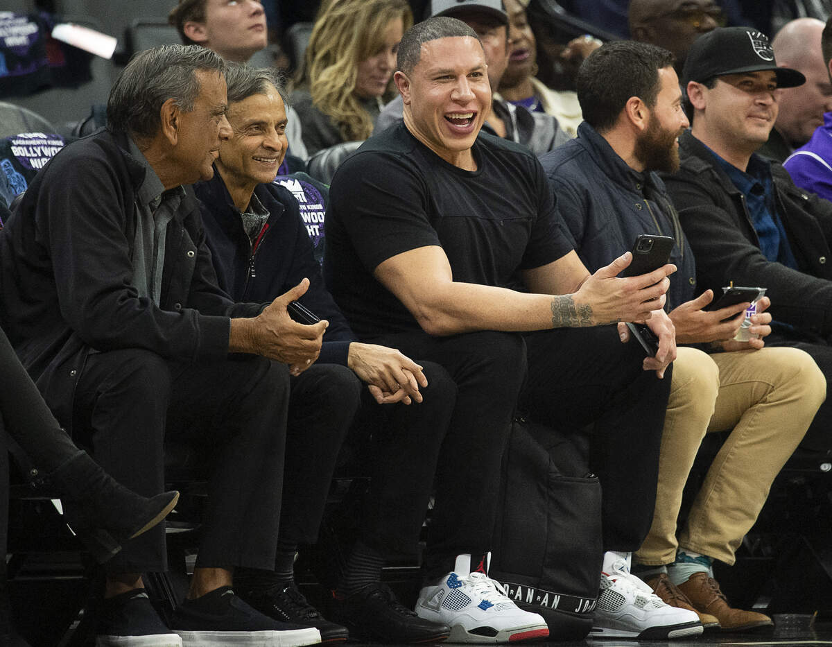 Former Sacramento Kings player Mike Bibby laughs with Kings owner Vivek Ranadive with during a game at Golden 1 Center on Monday, Jan. 6, 2020 in Sacramento.