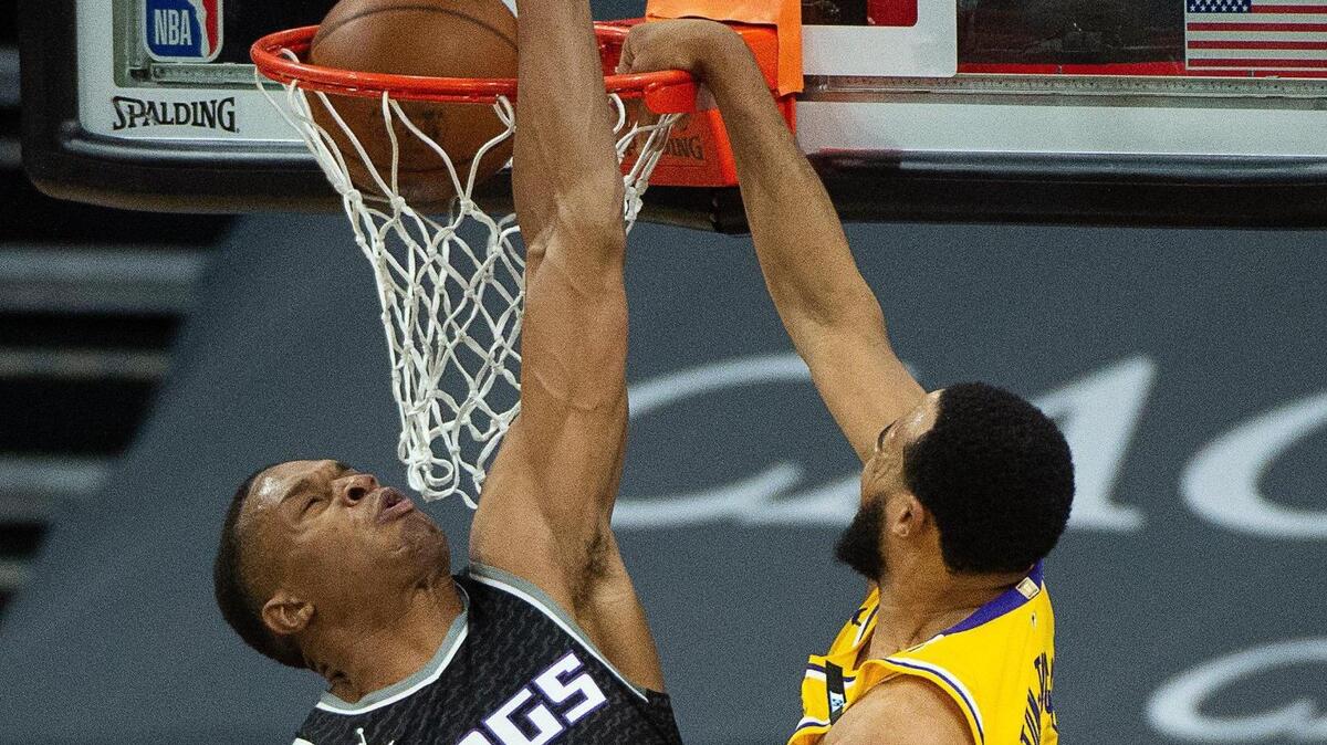 Los Angeles Lakers guard Talen Horton-Tucker (5) layup ball over Sacramento Kings forward Robert Woodard II (13) in the fourth quarter during a game at Golden 1 Center on Friday, April 2, 2021 in Sacramento.