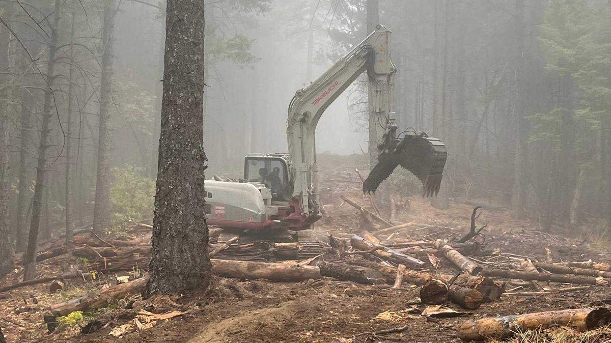 An excavator performs fire suppression repair Nov. 3 on the west side of the Shoe Fire’s contingency line in the Shasta-Trinity National Forest. U.S. Forest Service officials said Monday that the fire that had been burning since Oct. 9 was 100% contained.