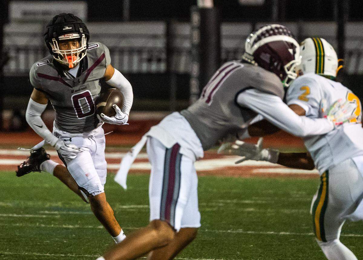 Woodcreek Timberwolves wide receiver Trace Murchison (0) brings the ball upfield against the Rio Americano Raiders in a CIF Sac-Joaquin Division III semifinal playoff game in Roseville on Friday, Nov. 21, 2025. 