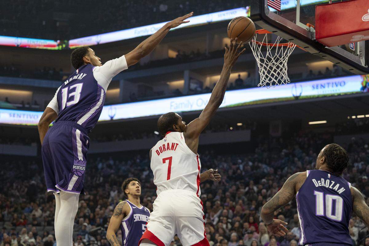 Sacramento Kings forward Keegan Murray (13) attempts to block Houston Rockets forward Kevin Durant (7) at Golden 1 Center in Sacramento on Sunday.