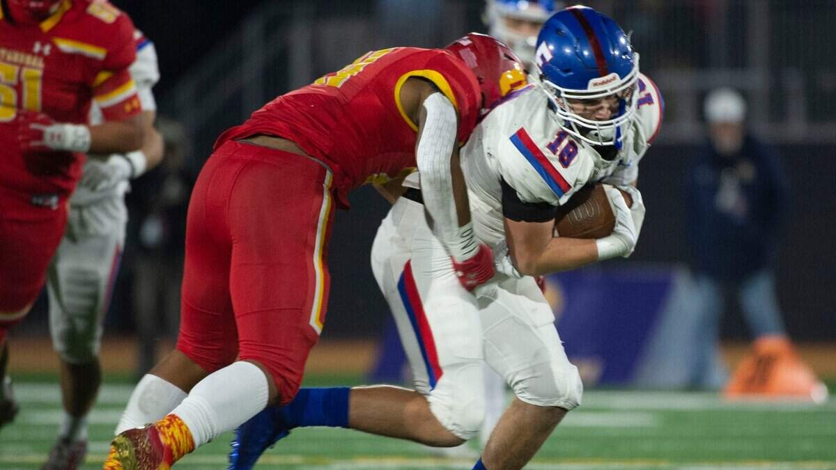 Folsom’s Mason Norberg makes a catch for a first down against Cathedral Catholic’s Noah Allen during the CIF State Division I-AA Championship in Mission Viejo on Friday, Dec. 10, 2021.
