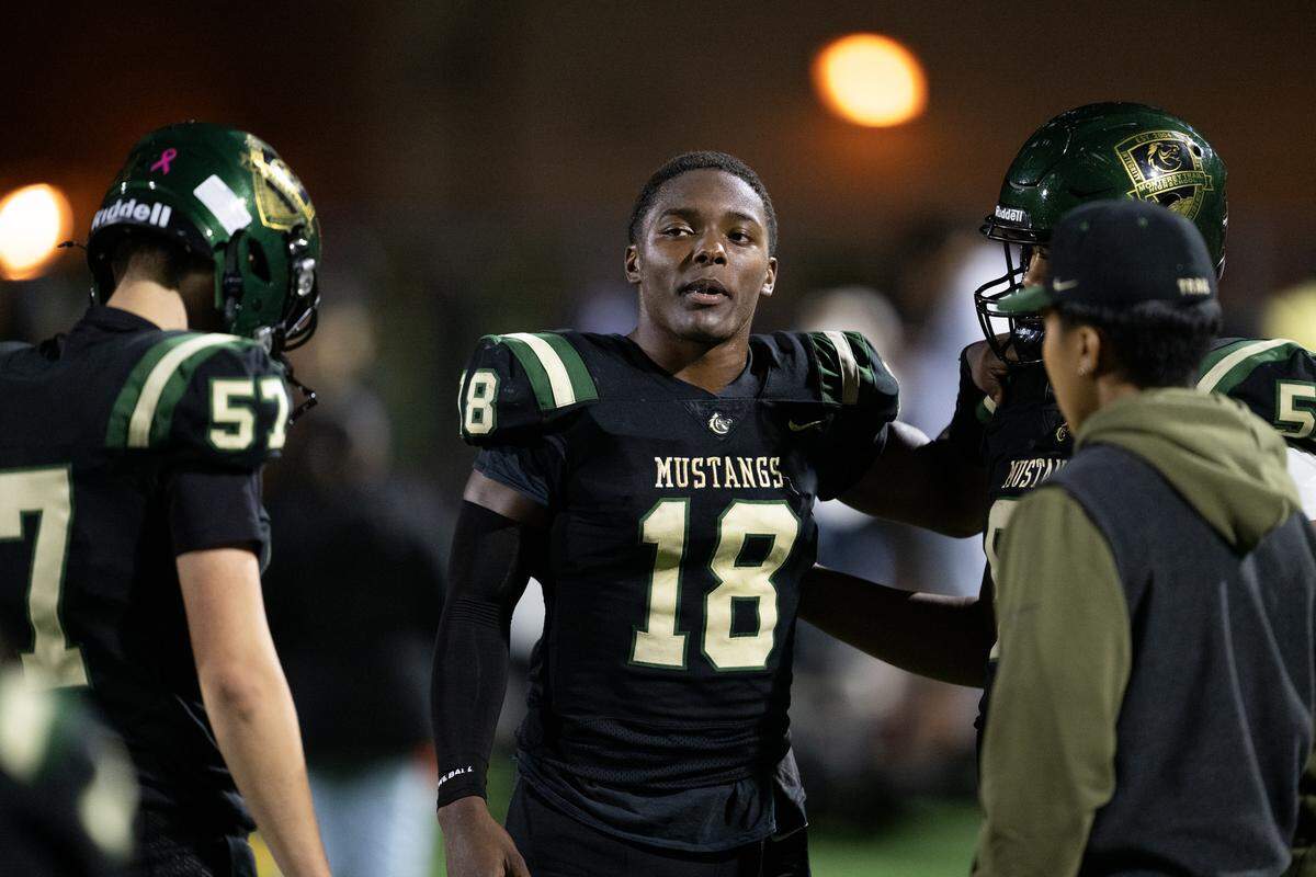 The Monterey Trail Mustangs’ Kaden Love (18) walks the sidelines after an injury in the CIF Sac-Joaquin Section Division l quarterfinal football playoff game against the Inderkum Tigers at Monterey Trail High School on Friday in Elk Grove.