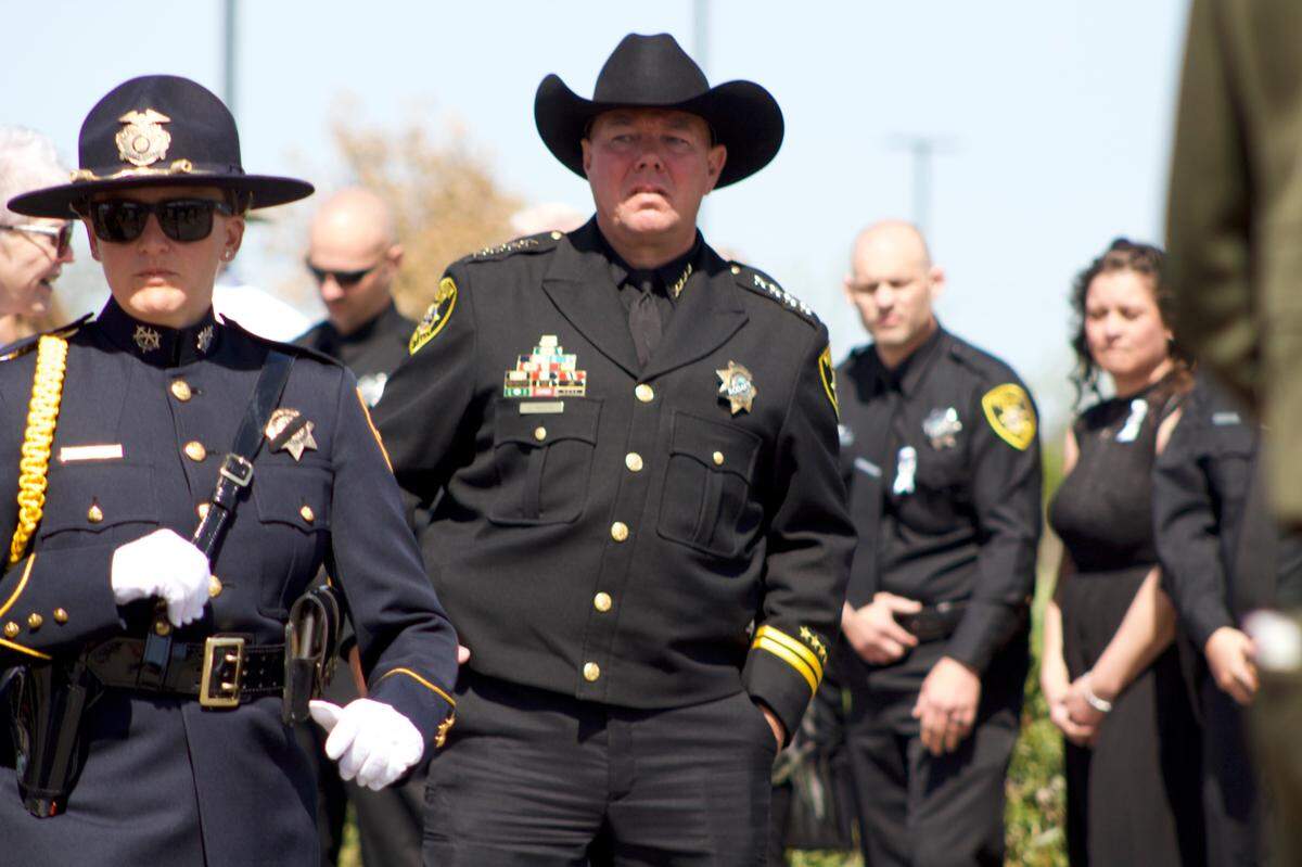 Marysville Police Chief Christian Sachs stands Tuesday, April 8, 2025, outside of the celebration of life for officer Osmar Rodarte as hundreds of officers organize along the roadway outside of the venue to meet the procession carrying the fallen officer’s body.