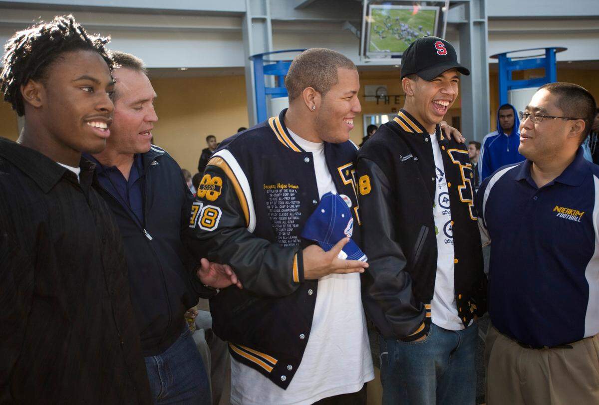 Greg Grimes, center, celebrates signing a letter of intent at Inderkum High School on Wednesday, Feb. 6, 2008, to attend Boise State. Grimes was fatally shot outside a downtown nightclub on 16th and L streets early Monday.