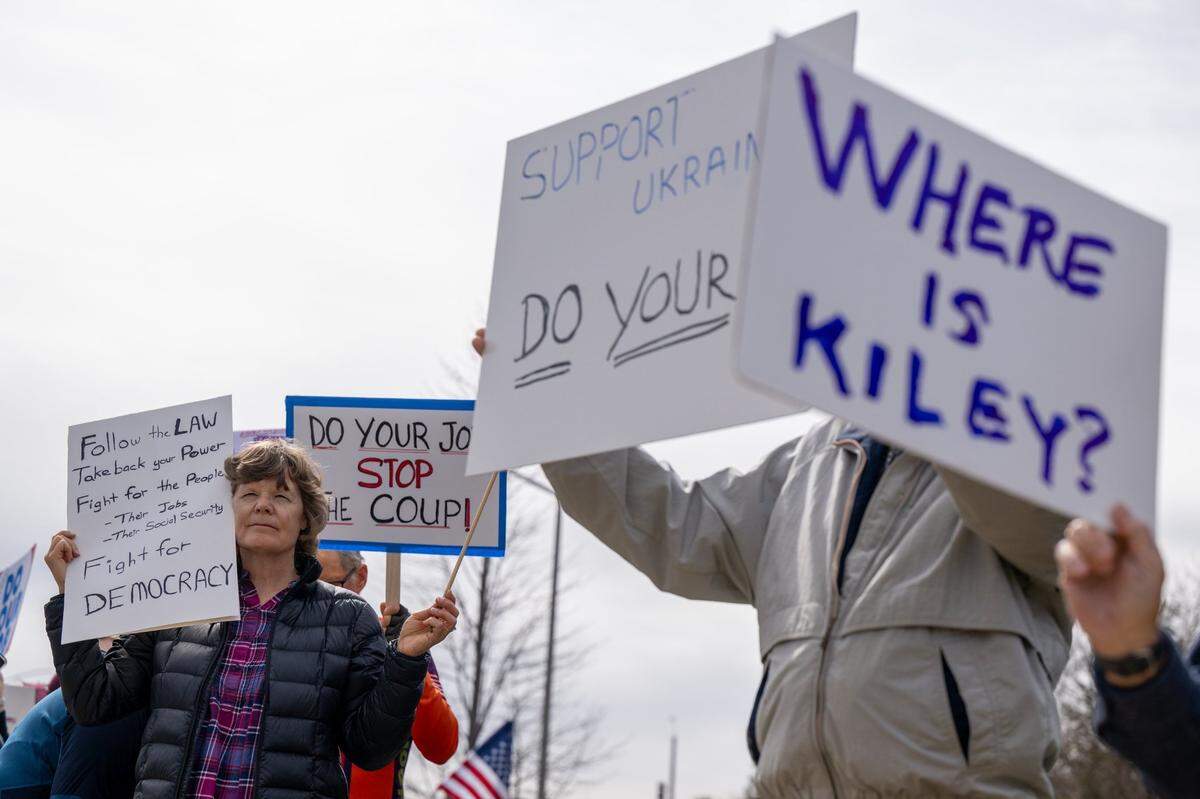 Diana Kostka of Auburn, left, joins a group of about 70 people protesting Trump administration polices outside the office of Congressman Kevin Kiley on Tuesday, March 4, 2025, in Rocklin.