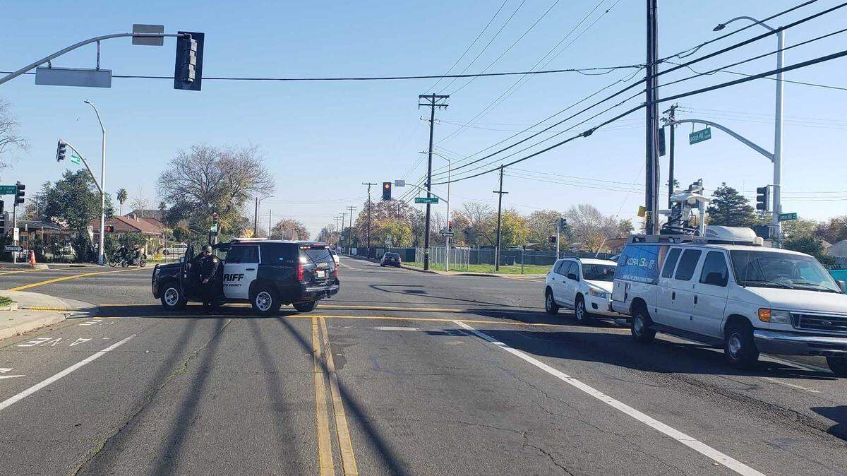 A Sacramento police vehicle blocks an intersection as officers hunted for a suspect who shot at police on Sunday, Nov. 28, 2021.