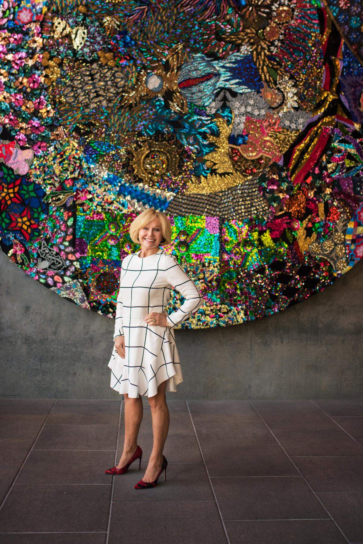 Vintner Kathryn Hall poses for a picture in front of “Garden Plot” by Nick Cave,” on display at Hall Wines in St. Helena.