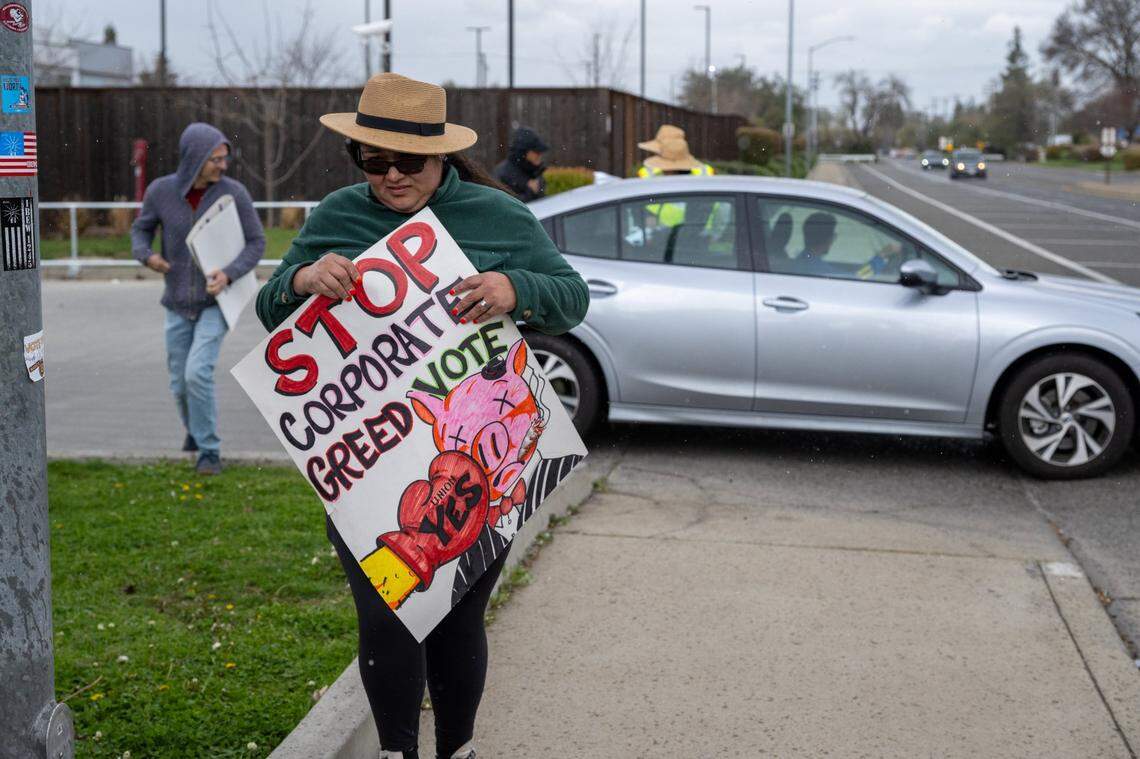 Members of local labor unions hold signs at the Siemens Mobility plant in south Sacramento on Wednesday, the day before a unionization vote at the plant. The facility, which builds railcars for Amtrak and light rail systems, employs 1,600 manufacturing workers.