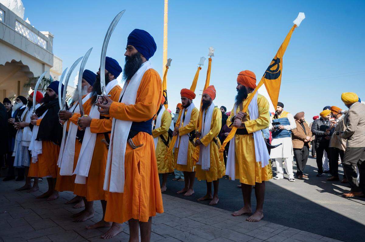 The five men, known as the Panj Pyare, stand in front of the float with the Holy Scripture on Sunday to mark the start of the Sacramento Sikh Society’s first Nagar Kirtan parade at the society’s temple on Bradshaw Road in Sacramento County. The event is a Sikh custom that involves the singing of holy hymns in a processional through a community.