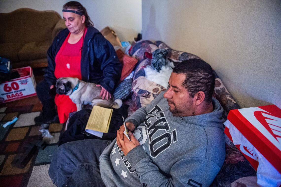 Julian Garcia looks at a picture on Tuesday of his cousin Robert Stephen Calderon, who shot and killed a Sacramento County Sheriff’s deputy and K9 on Monday night before he was killed by officers. His wife Carey Chilos pets Max, Calderon’s pug, at their home. “He was like my brother,” Garcia said through tears. “I really want to send my condolences to the police officer, and the dog, that passed away, and their families. We’re sorry.”