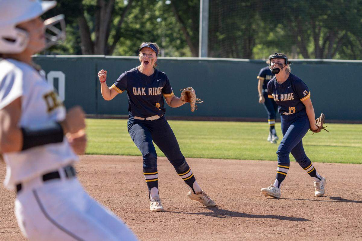 The Oak Ridge Trojans’ Carly Short and Ellison Schroeder celebrate an out during the CIF Sac-Joaquin Section Division I championship softball game against the Del Oro Eagles at Sacramento State on Saturday.