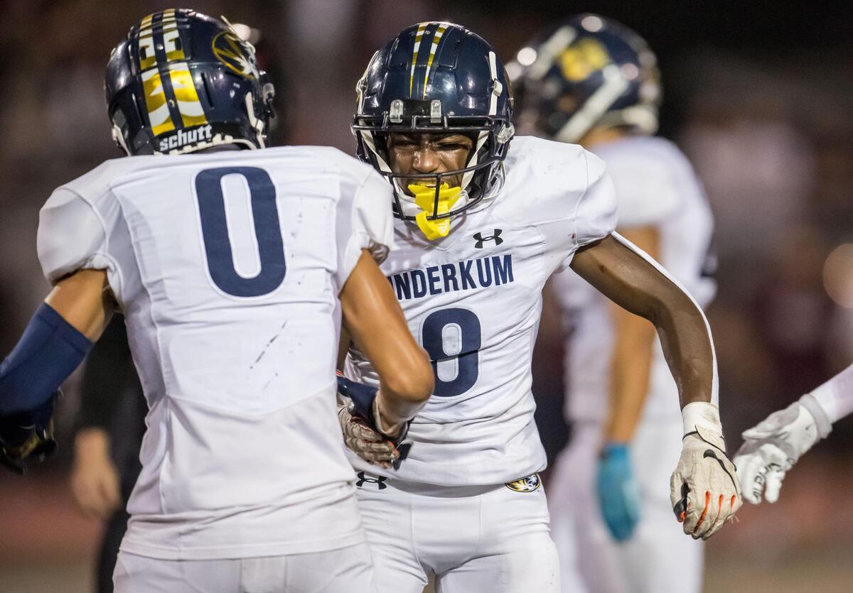 Inderkum Tigers defensive back Kyle Gurganious (8), center, celebrates with teammate Christian Harris (0) after tackling Woodcreek Timberwolves running back Brody Krupp (2) for a loss of yards in the backfield at Woodcreek High School in Roseville in September.