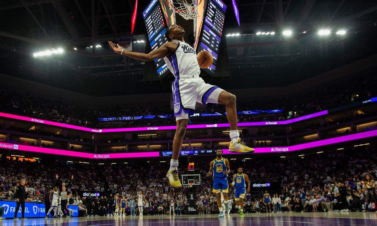 Sacramento Kings guard De’Aaron Fox follows through on a breakaway dunk during an NBA play-in game against the Golden State Warriors on April 16 at Golden 1 Center.