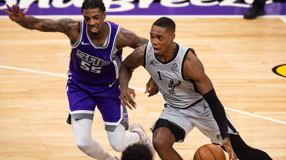 Sacramento Kings guard Delon Wright (55), left, defends against San Antonio Spurs guard-forward Lonnie Walker IV (1) during the fourth period of the NBA game Friday, May 7, 2021, at Golden 1 Center in downtown Sacramento. The Spurs beat the Kings, 113-104.