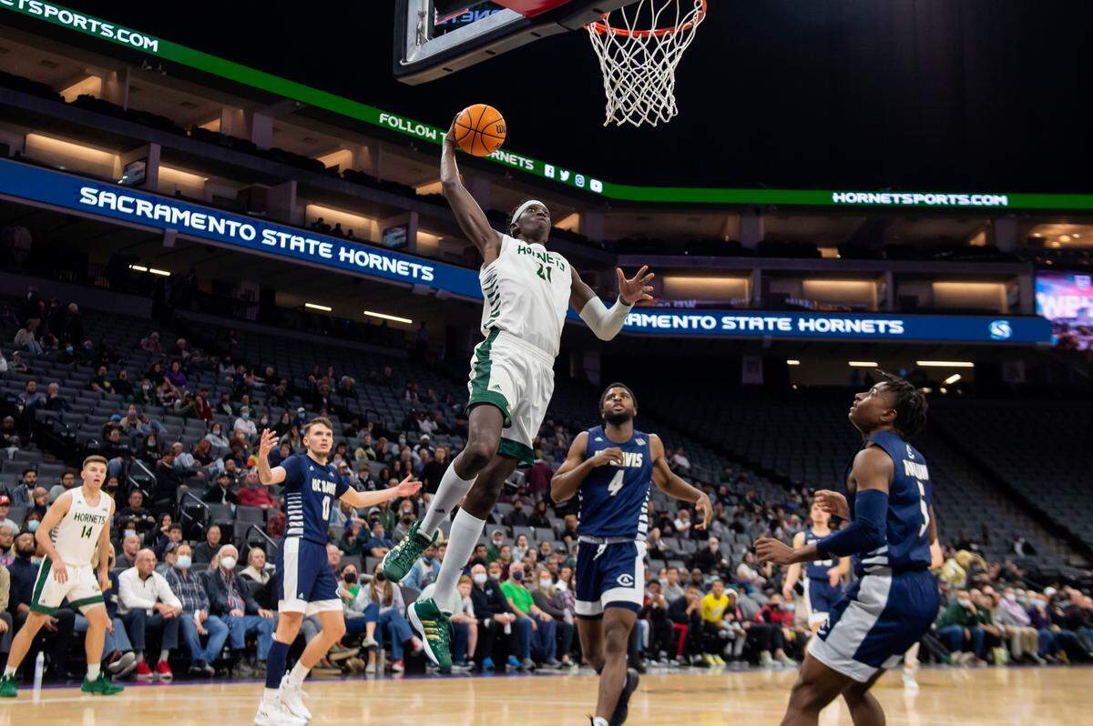 Sacramento State Hornets center Jonathan Komagum (21) dunks during a game against UC Davis at Golden 1 Center in Sacramento in 2021.