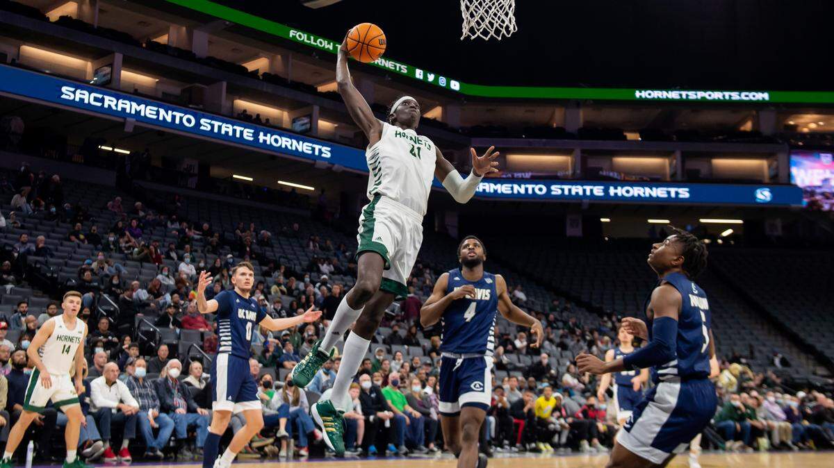 Sacramento State Hornets center Jonathan Komagum (21) dunks the ball during the second half on Tuesday, Nov. 23, 2021 during a nonconference basketball game at the Golden 1 Center in Sacramento. Komagum had a double-double with 13 points and 12 rebounds. The Hornets won 75-63.