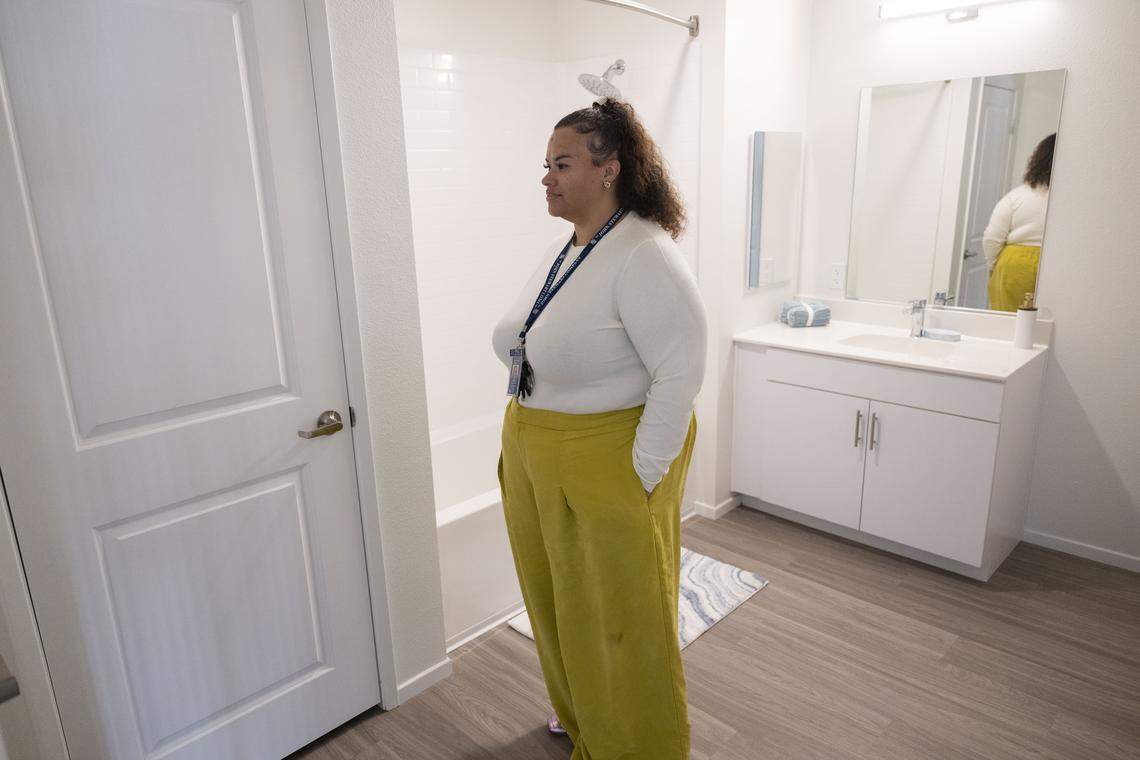 Michelle Michael, property manager at The Padres, stands in the bathroom of one of the project's affordable Elk Grove apartments in October.
