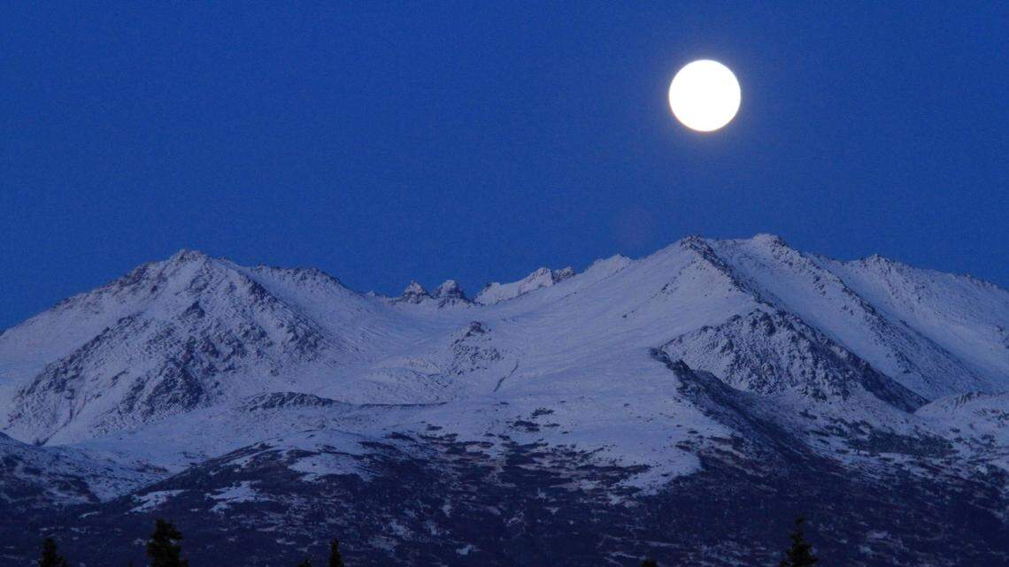 The moon rises over the Chugach Mountains in 2012. Michael Hamilton, 26, a heli-skier guide known as a “local legend” died April 25 after being swept over a cliff by an avalanche, Alaska officials say.