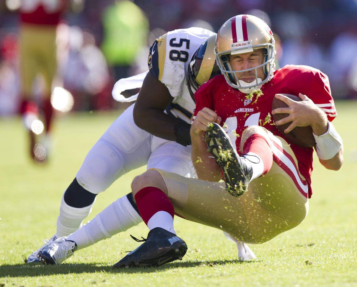 San Francisco 49ers quarterback Alex Smith (11) is tackled by St. Louis Rams outside linebacker Jo-Lonn Dunbar (58) at Candlestick Park in 2012. Smith had a concussion from the play.
