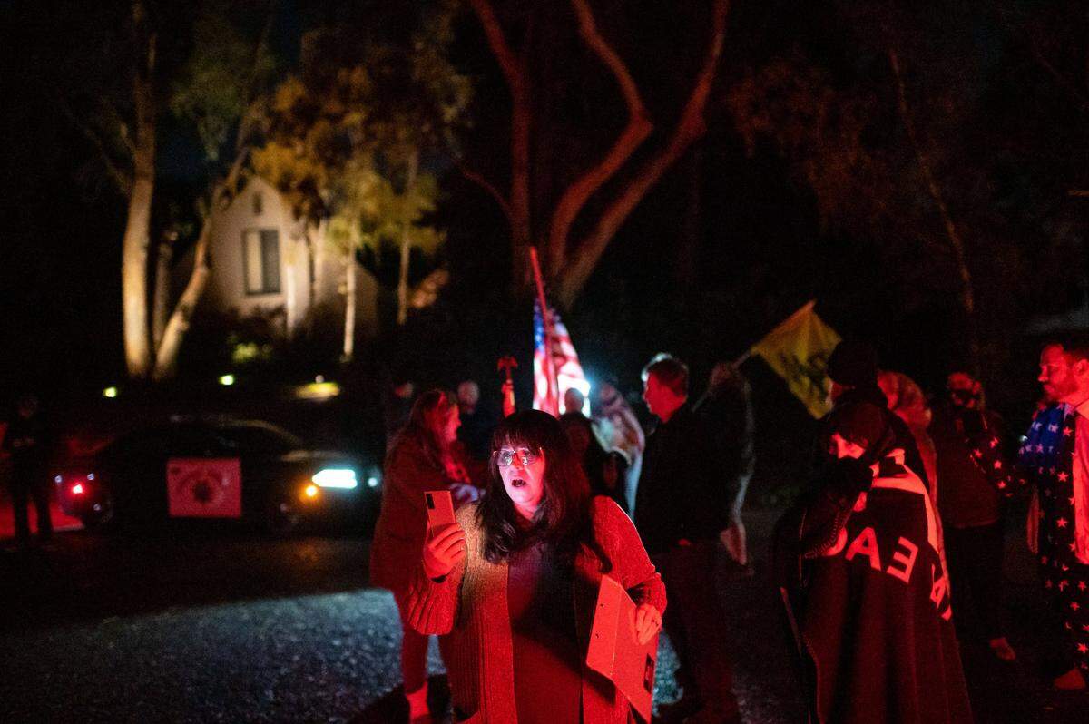 Republican Chris Bish, who lost her race for the 6th congressional district, livestreams outside of California Gov. Gavin Newsom’s home in protest on the first night of a coronavirus curfew Saturday, Nov. 21, 2020, in Fair Oaks. Newsom’s office announced the overnight stay-at-home order, restricting non-essential activities, for most of California in an effort to slow the spread of COVID-19.