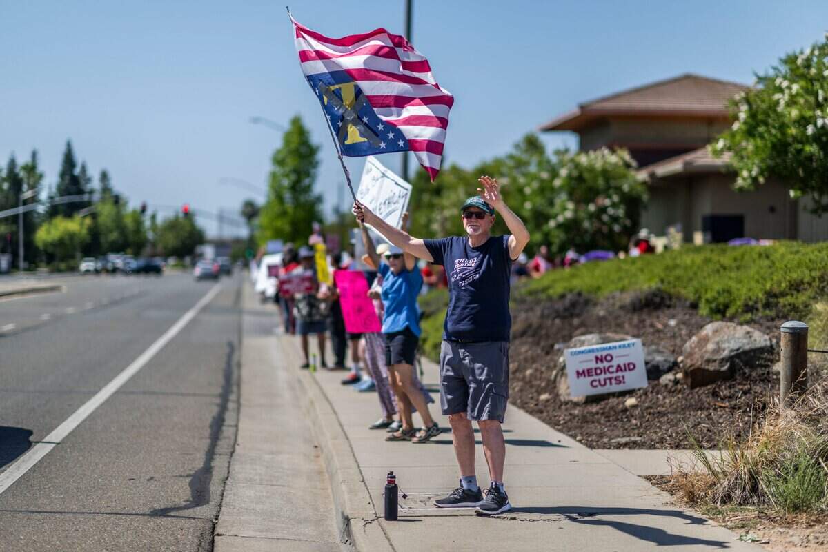 Jeff Engle, of Rocklin, joins registered nurses in a rally against Medicaid cuts outside Rep. Kevin Kiley’s district office in Rocklin on Tuesday. The cuts are part of legislation in Congress known as President Trump’s Big Beautiful Bill, which had passed the Senate earlier in the day and must now return to the House.