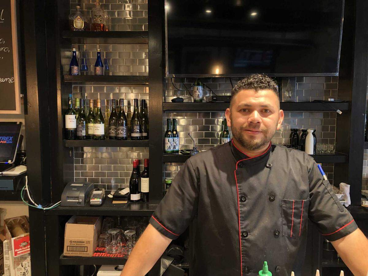 Sushi Bar owner Abel Bustillo smiles behind the bar on Thursday, Jan. 5, 2023. He said Sushi Bar is an extension of the Limon É Sal Taqueria and Bar to offer customers Mexican and Japanese cuisine. Sushi Bar is one of five Bee-featured restaurants in the Folsom area that opened late 2022.