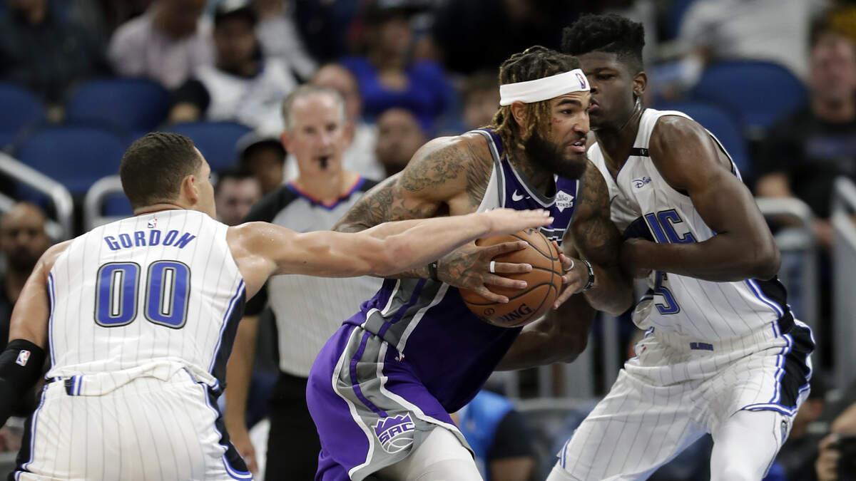 Kings center Willie Cauley-Stein, center, drives between Orlando Magic’s Aaron Gordon and Mohamed Bamba on Tuesday in Orlando, Fla. Cauley-Stein had 14 points and 11 rebounds as the Kings won 107-99 for their fourth consecutive victory.
