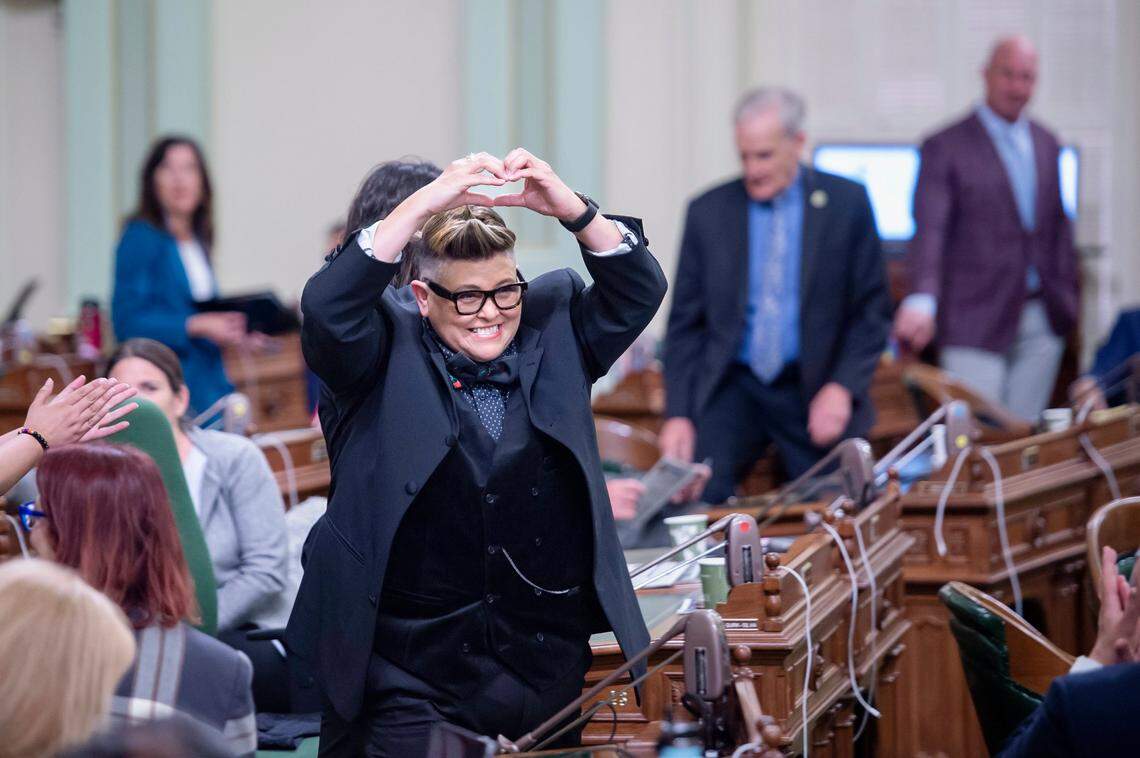 Irene M. Gutierrez, known as DJ Irene, makes a heart as she walks onto the Assembly floor to be recognized as an honoree during the Latino Spirit Awards on Monday at the state Capitol.