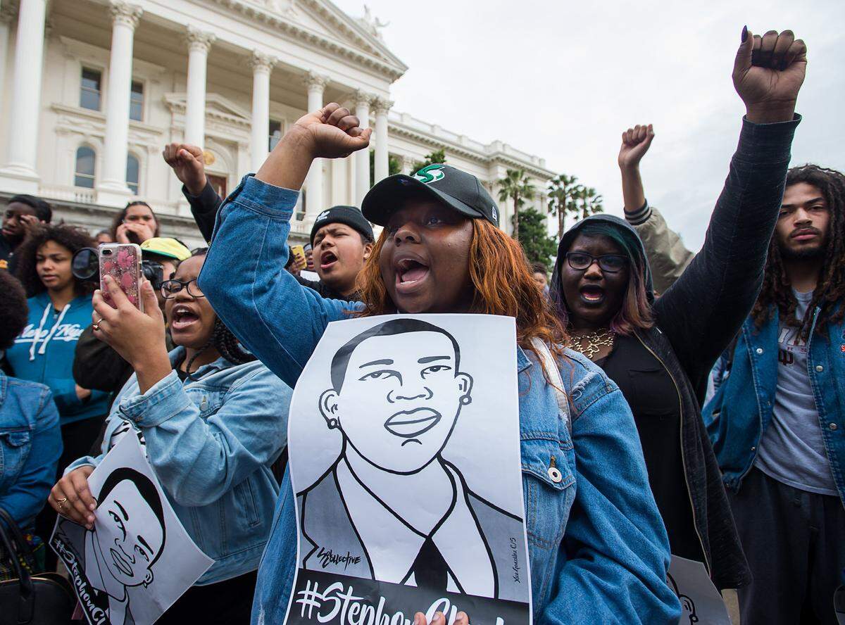 Sacramento State student Rahmatllah Mohammed   shows support of Stephon Clark during a student protest organized by the Black Student Union at the State Capital on Thursday, March 7, 2019 in Sacramento.