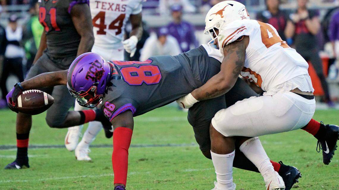 TCU tight end Artayvious Lynn is tackled by Texas linebacker Ayodele Adeoye in a game on Oct. 26, 2019.