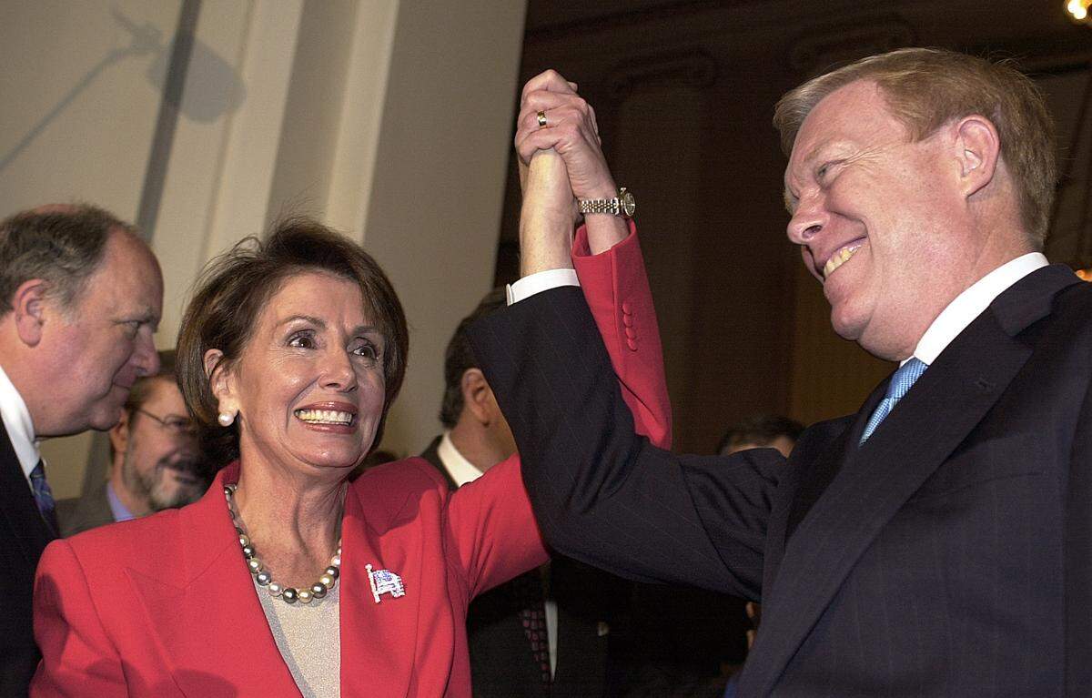 Rep. Nancy Pelosi, D-Calif., the newly elected Democratic Minority Leader, raises her hand with outgoing leader Dick Gephardt of Missouri on Nov. 14,  2002, on Capitol Hill in Washington, D.C. Pelosi's election marks the first time in the history of the Congress that a woman will lead her party.        