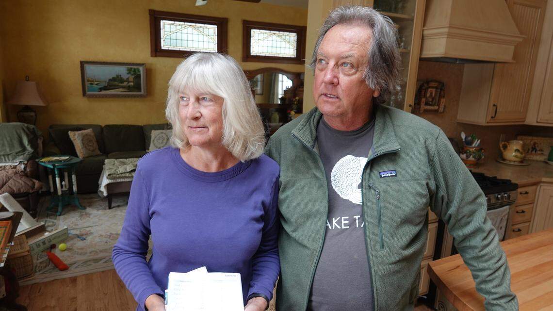 Laura and Ed Haneveld stand in their Olympic Valley home with a checklist of items they’d try to save during a wildfire. The couple worries a proposal to add hundreds of homes and nearly 300,000 square feet of commercial development at Squaw Valley Resort could hinder an evacuation.