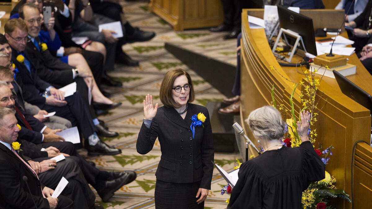 Gov. Kate Brown is sworn in before she addresses the state legislature at her inauguration at her inauguration at the Oregon state Capitol in Salem, Ore., Monday, Jan. 14, 2019. Oregon needs to shore up health care, the environment, the education system and housing, Gov. Kate Brown said during her State of the State address Monday. (Michaela Roman/Statesman-Journal via AP)