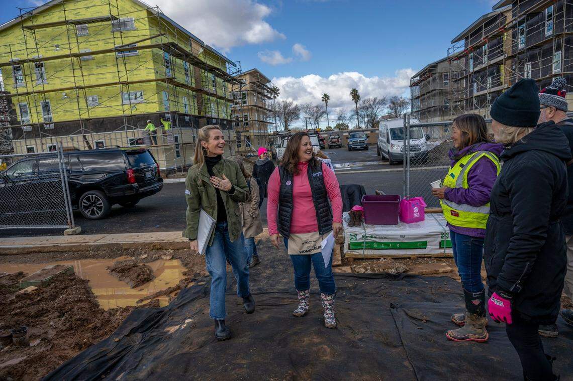 First Partner Jennifer Siebel Newsom, left, walks alongside Holly Martinez, executive director of The California Commission on the Status of Women and Girls, to celebrate International Women’s Day alongside women leaders and legislators who volunteered as Part of Habitat for Humanity’s 2023 Women Build event in Sacramento on Wednesday.