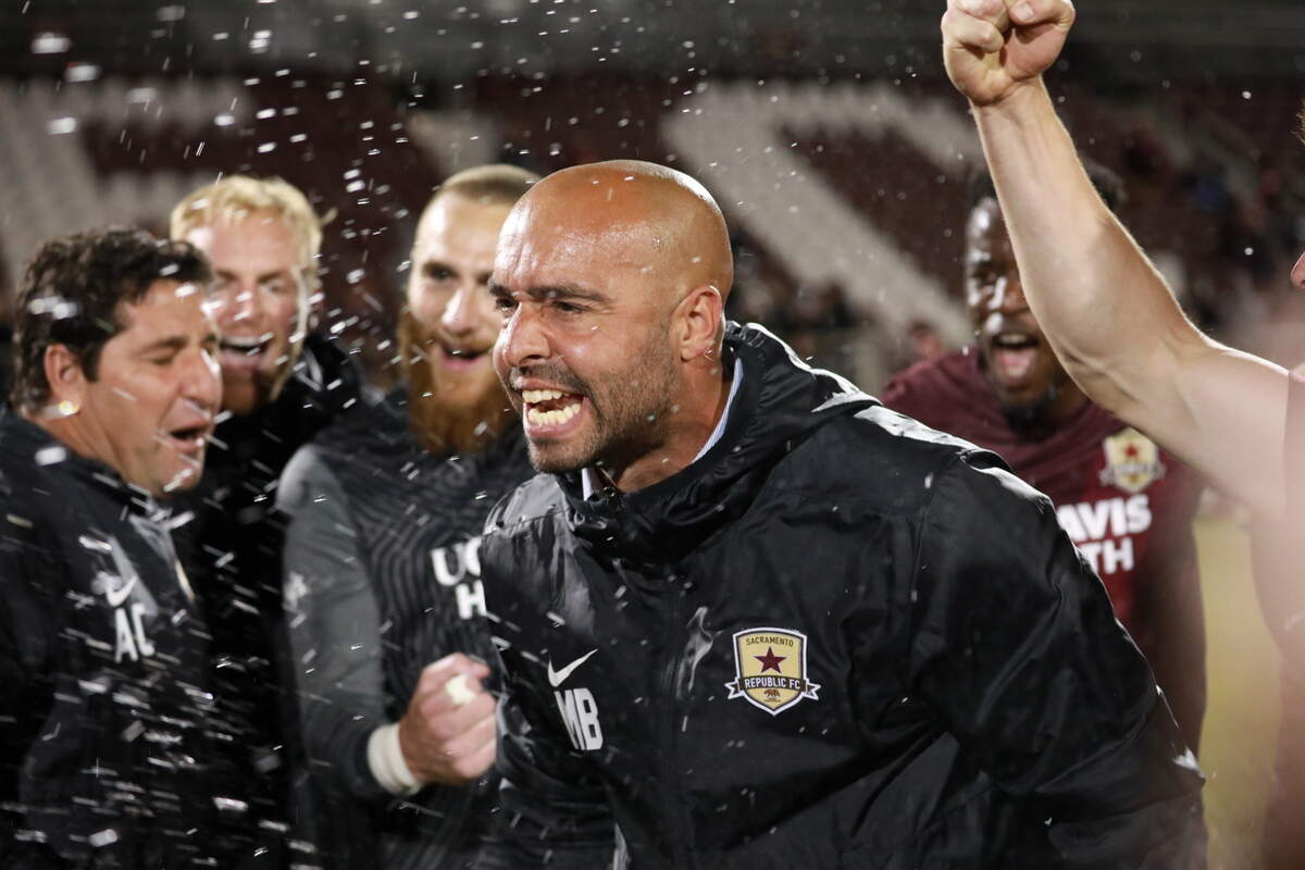 Coach Mark Briggs celebrates a U.S. Open Cup win with players Wednesday, May 11, 2022.