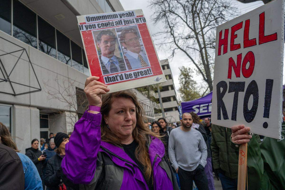 Carolyn Lambert holds a sign comparing Gov. Gavin Newsom to a character from the film “Office Space” outside CalHR offices in Sacramento on Wednesday as she joined hundreds to protest the governor’s order directing state workers to return to their offices four days a week.