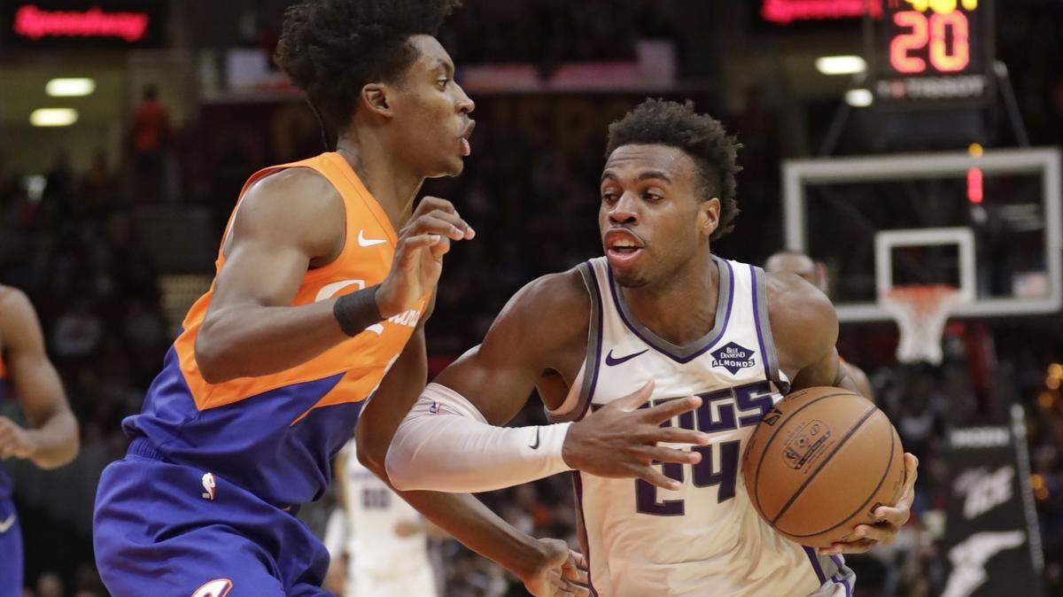Sacramento Kings’ Buddy Hield (24), from Bahamas, drives past Cleveland Cavaliers’ Collin Sexton (2) in the second half of an NBA basketball game, Friday, Dec. 7, 2018, in Cleveland. (AP Photo/Tony Dejak)