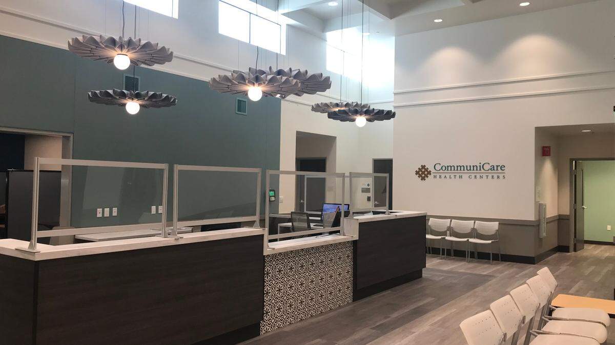 Patients will enter a waiting room with a coffered ceiling and pendant lights surrounded by an intricately folded skirt.