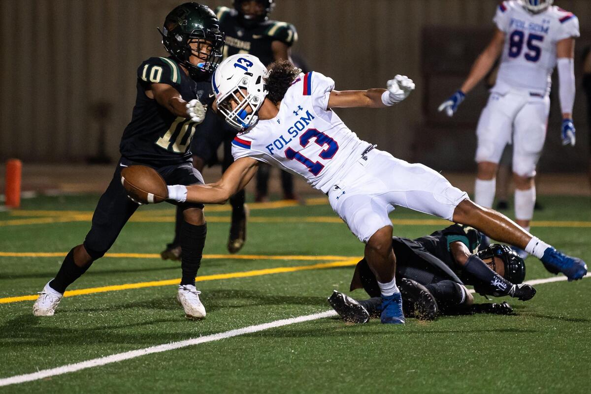 Folsom wide receiver Rico Flores Jr. reaches into the end zone to score on a pass from Tyler Tremain in the second quarter as Monterey Trail’s Arik Phillips, left, and Mizay Davis defend during the nonleague high school football game Friday, Aug. 20, 2021, at Monterey Trail High School in Elk Grove.