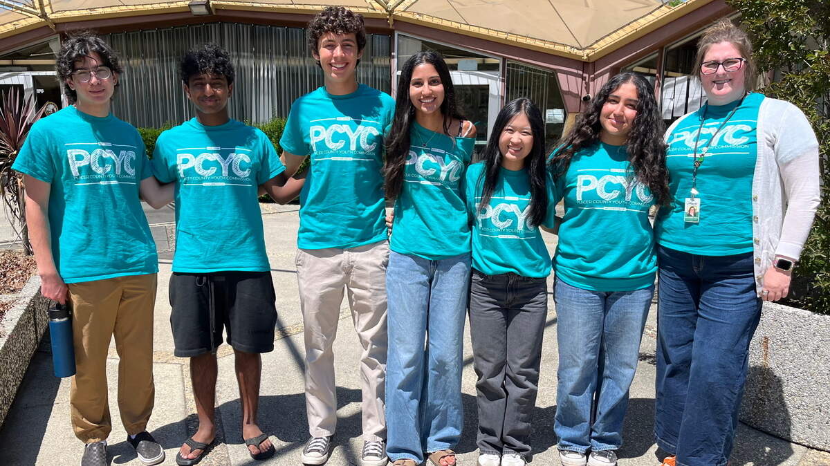 Placer County Youth Commissioners Ashley Kim (third from right) and Arini Tandon (second from right) presented their forthcoming children’s book at a county Board of Supervisors meeting on June 10. The book will inform elementary schoolers about the dangers of substance abuse.