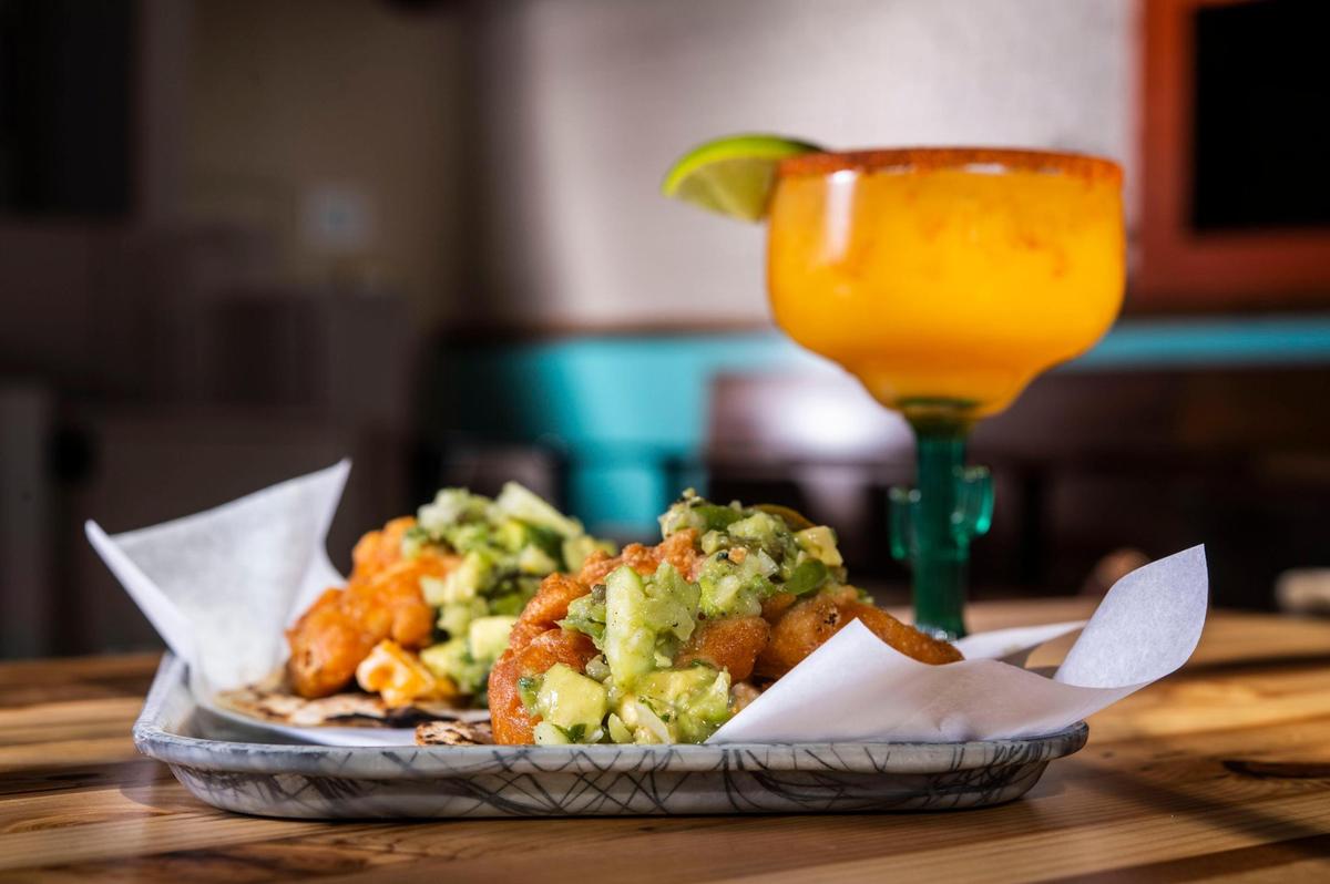 Baja tacos which are made from cider battered cauliflower, chipotle crema slaw and avocado verde Monday, Feb. 28, 2022, at Bambi Vegan Tacos in Sacramento. They’re served here with a mango margarita.