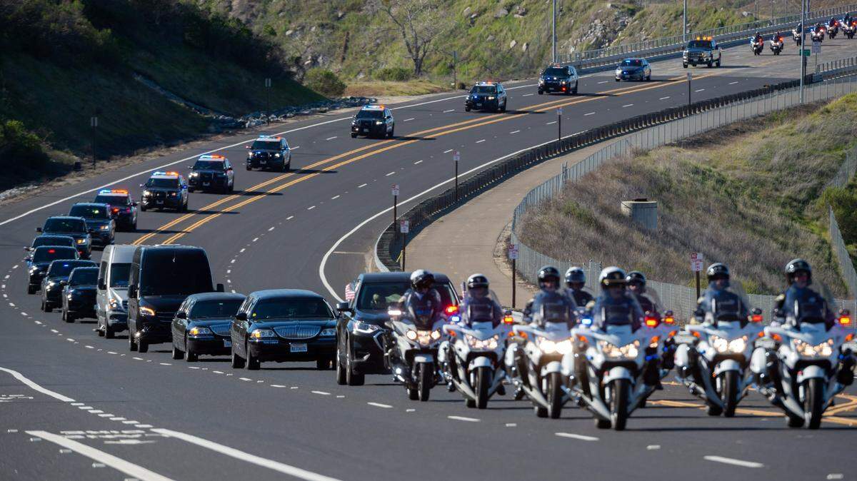 The funeral procession for Elk Grove police officer Tyler Lenehan crosses the Folsom Lake Crossing bridge on its way to his final resting place in the community of Rescue on Tuesday, Feb. 1, 2022.