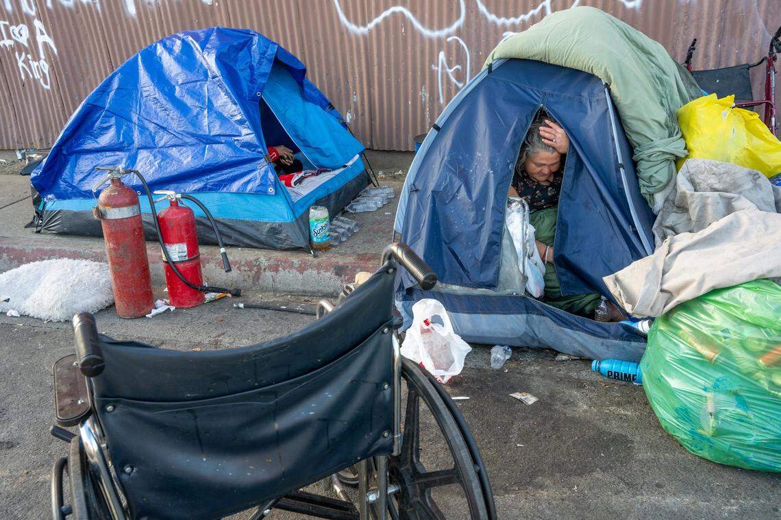 Theresa Rivera, 45, camps in a tent in Sacramento in November. In March, Rivera received a city citation and after a missed court date now owes $333. Rivera, who uses a wheelchair to get around, says that most days she doesn’t even have $5 in her pocket.